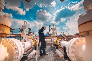 male-worker-inspection-steel-long-pipes-pipe-elbow-station-oil-factory-during-refinery-valve-visual-check-record-pipeline-tank-oil-gas